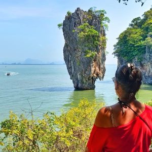 Discover Paradise Woman Gazing at the Iconic James Bond Island's Dramatic Limestone Pinnacles from Emerald Waters